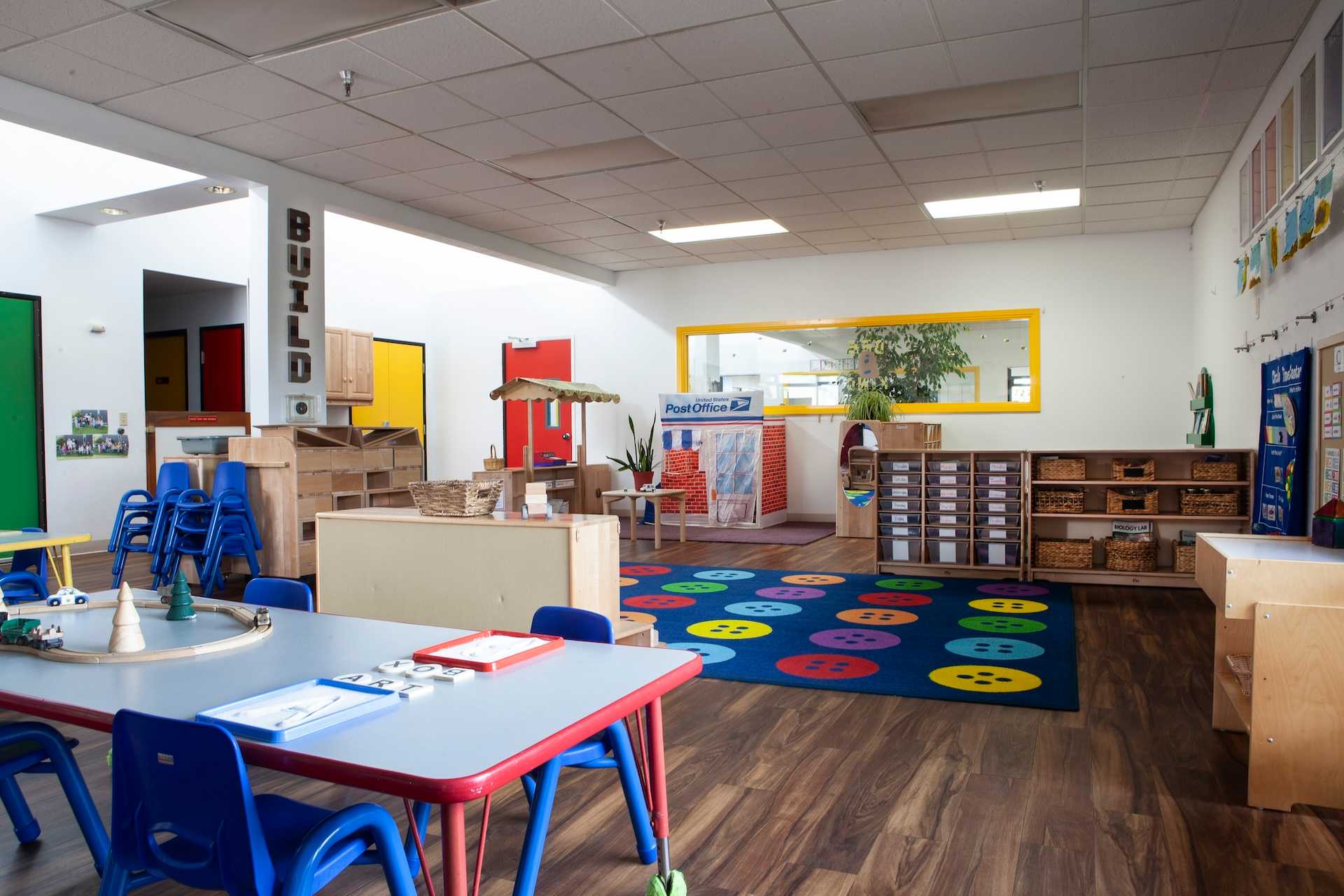 Bright Columbia Children's Center classroom with play areas, books, and child-sized furniture